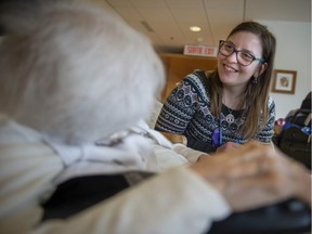 Zoe Chalkousi visits with a patient at Ste-Anne Hospital in Ste-Anne-de-Bellevue.