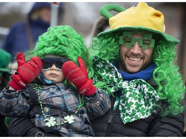 Kevin Fauquembergue enjoys the 10th Annual Hudson St. Patrick's Parade with his son Matthew in Hudson Quebec, west of Montreal, on Saturday, March 16, 2019.