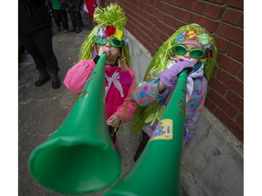 Pincourt Sparks members Layla Zaghlool left, and Alexis Dwyer right practice blowing the Vuvuzela Horns before they make their way along main street during the 10th Annual Hudson St. Patrick's Parade in Hudson.