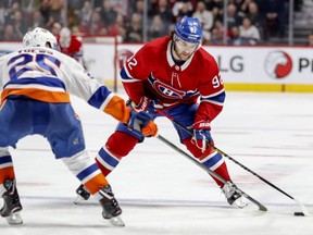 Montreal Canadiens winger Jonathan Drouin crosses the blue line with the puck while being defended by New York Islanders' Devon Toews during third period in Montreal on March 21, 2019.