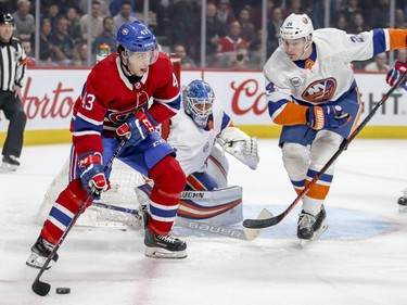 Montreal Canadiens' Jordan Weal looks to make a pass next to New York Islanders goalie Thomas Greiss and defenceman Scott Mayfield during first period of National Hockey League game in Montreal Thursday March 21, 2019.