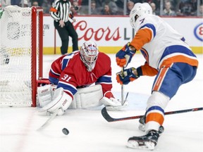 Canadiens' Carey Price pokes the puck off the stick of Islanders' forward Jordan Eberle during second period Thursday night at the Bell Centre.