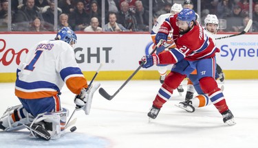 Montreal Canadiens' Nate Thompson takes a shot on New York Islanders' Thomas Greiss during first period of National Hockey League game in Montreal Thursday March 21, 2019.