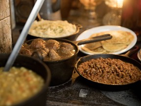 Classic sugar shack food warms on an antique oven at Sucrerie La Montagne in Rigaud in 2019. Here we have pea soup, meatballs, mashed potatoes, beans and pancakes.