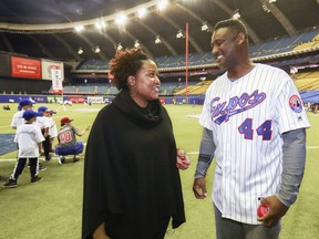 Meta Robinson, Jackie Robinson's grand-daughter, chats with former Montreal Expos Ken Hill on the field at the Olympic Stadium during Play Ball event held in Montreal Saturday March 23, 2019 in recognition of the centennial of Jackie Robinson's birth.