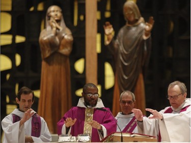 Father Bernard Antoine performs a mass at St Joseph's Oratory in Montreal Sunday, March 24, 2019. This is the first Sunday Mass after an attack on the rector on Friday.