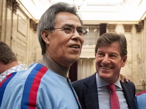 Dennis Martinez greets Stephen Bronfman as a group of former Montreal Expos visit city hall in Montreal, on Monday, March 25, 2019.
