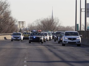 Police try to keep one lane open on Highway 40 Monday morning as taxi drivers protest by slowing down traffic.