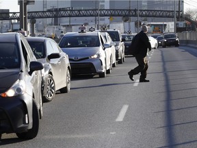 Taxi drivers bring Cote-de-Liesse to a halt during a strike by taxi drivers as they protest new legislation deregulating parts of the taxi industry in Montreal, on Monday, March 25, 2019.