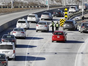 Police block taxis from entering the Pierre-Elliott-Trudeau Airport during a strike by taxi drivers as they protest new legislation deregulating parts of the taxi industry in Montreal, on Monday, March 25, 2019.