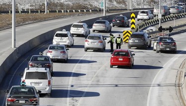 Police block taxis from entering the Pierre-Elliott-Trudeau Airport during a strike by taxi drivers as they protest new legislation deregulating parts of the taxi industry in Montreal, on Monday, March 25, 2019.