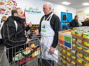"It's much better to be able to choose; it's more dignified," St-Léonard resident Belkacem Slimani, left, says of the market-style food bank on Henri-Bourassa Blvd. At right is Welcome Hall Mission president and CEO Sam Watts.
