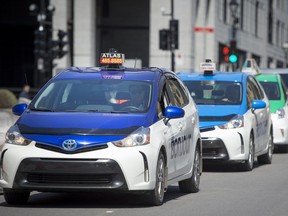 Taxis wait outside Montreal city hall in 2017.