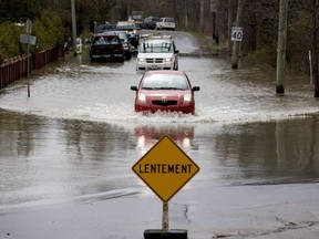 A motorist braves the deep water that formed on Main Road in Hudson during the spring floods of 2017. This spring, puddle problems are a concern for Off-Island homeowners.