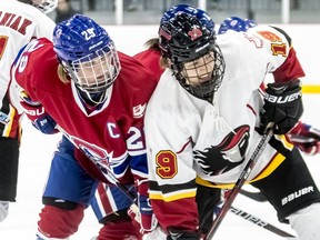 Les Canadiennes captain Marie-Philip Poulin and Calgary Inferno Brianne Jenner at a faceoff during a 3-1 loss to Calgary at Place Bell in Laval on Oct. 14, 2018.