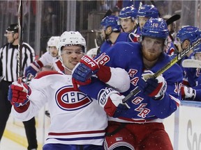 The Canadiens’ Max Domi and the New York Rangers’ Marc Staal battle for position during NHL game at Madison Square Garden on Nov. 6, 2018.