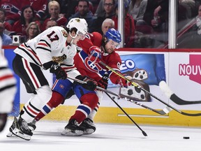 Canadiens' Jonathan Drouin skates the puck against Dylan Strome of the Chicago Blackhawks at the Bell Centre on Saturday, March 16, 2019.