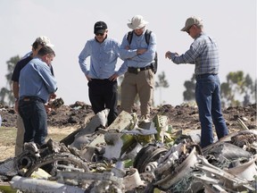 Investigators with the U.S. National Transportation and Safety Board look over debris at the crash site of Ethiopian Airlines Flight ET 302 on March 12, 2019 in Bishoftu, Ethiopia. All 157 passengers and crew perished after the Ethiopian Airlines Boeing 737 Max 8 Flight came down six minutes after taking off from Bole Airport in Addis Ababa.