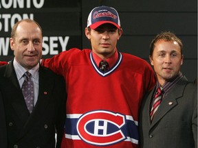 Fifth overall draft pick Carey Price of the Montreal Canadiens poses with team general manager Bob Gainey, left, and director of player personnel Trevor Timmins after being selected during the 2005 National Hockey League Draft on July 30, 2005, at the Westin Hotel in Ottawa.