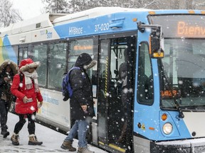 Passengers get on a hybrid bus at the Vendôme métro station in Montreal Tuesday Nov. 27, 2018.