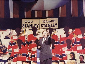 Auctioneer Serge Belec takes centre stage in from the Forum memorabilia March 12, 1996.