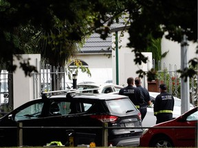 Security officials walk outside the Masjid al Noor mosque after a shooting incident in Christchurch on March 15, 2019. - Attacks on two Christchurch mosques left at least 49 dead on March 15.