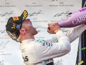 Mercedes' Finnish driver Valtteri Bottas celebrates on the podium after winning the Formula One Australian Grand Prix in Melbourne on March 17, 2019.