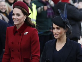 FILE - In this Tuesday, Dec. 25, 2018 file photo, Britain's Kate, Duchess of Cambridge, left, and Meghan, Duchess of Sussex arrive to attend the Christmas day service at St Mary Magdalene Church in Sandringham in Norfolk, England. Britain's royal family is warning that it will block trolls posting offensive messages on its social media channels _ and may report offenders to the police. Buckingham Palace, Clarence House and Kensington Palace issued new guidelines on Monday, March 4, 2019 spelling out the policy banning offensive, hateful and racist language.