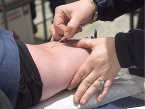 A man gives blood in Montreal, Thursday, November 29, 2012. "When used correctly, transfusions can be life saving. Indeed I would encourage those who are able to donate blood to do so when the opportunity arises. But transfusing people with the blood of young person, and charging them thousands of dollars for the privilege, exposes them to unnecessary risk and is frankly unjustifiable," Christopher Labos writes.