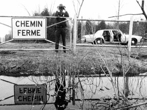 U.S. border patrol officer Tom McGrath stands at the Canada-U.S. border, just inside the United States somewhere south of Montreal, on March 23, 1990. This photo was published with a story the following day.