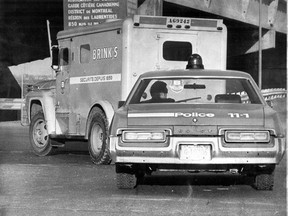 Police escort abandoned hijacked Brink's armoured car after a $2.8 million robbery in Montreal. This photo was published March 31, 1976.