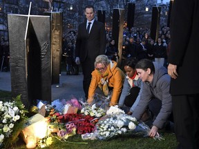 People take part in a vigil at the New Zealand War Memorial on Hyde Park Corner in London, Friday, March 15, 2019. Other members of Britain's royal family have followed Queen Elizabeth II in expressing their sadness over the shootings in Christchurch New Zealand.