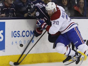 Canadiens' Nicolas Deslauriers, rubs out Jackets' Nick Foligno along the boards Thursday night in Columbus, Ohio.