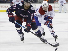 Blue Jackets' Brandon Dubinsky, left, tries to keep the puck away from Canadiens' Jordan Weal Thursday night in Columbus, Ohio.