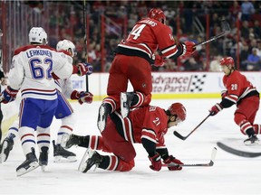 Carolina Hurricanes' Justin Williams (14) jumps over teammate Nino Niederreiter while Montreal Canadiens' Artturi Lehkonen (62) chases the puck during the first period in Raleigh, N.C., on Sunday, March 24, 2019.
