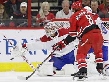 Montreal Canadiens goalie Carey Price (31) blocks Carolina Hurricanes' Saku Maenalanen (8), of Finland, during the first period of an NHL hockey game in Raleigh, N.C., Sunday, March 24, 2019.