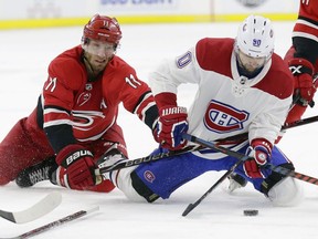 Carolina Hurricanes' Jordan Staal (11) and Trevor van Riemsdyk (57) skate for the puck with Montreal Canadiens' Tomas Tatar (90), of Slovakia, during the second period of an NHL hockey game in Raleigh, N.C., Sunday, March 24, 2019.