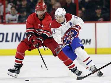 Carolina Hurricanes' Jordan Staal, left, and Montreal Canadiens Brendan Gallagher (11) chase the puck during the first period of an NHL hockey game in Raleigh, N.C., Sunday, March 24, 2019.