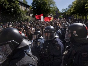 Protesters march through in Quebec City on Saturday, June 9, 2018, as the G7 summit closes.