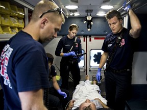 Paramedics treat a patient who overdosed on heroin in Delray Beach, Fla., Feb. 2, 2017. The number of deaths from alcohol, drugs and suicide in 2017 hit the highest level since the collection of federal mortality data started in 1999, according to an analysis by two public health nonprofits.