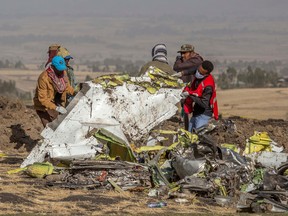 Rescuers work at the scene of an Ethiopian Airlines flight crash near Bishoftu, or Debre Zeit, south of Addis Ababa, Ethiopia, on Monday. A spokesman says Ethiopian Airlines has grounded all its Boeing 737 Max 8 aircraft as a safety precaution, following the crash of one of its planes in which 157 people were killed.