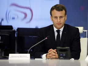 In this photo taken on Saturday, March 16, 2019, French President Emmanuel Macron presides over an emergency crisis meeting at the Interior Ministry in Paris , France. Paris police say more than 100 people have been arrested amid rioting in the French capital by yellow vest protesters and clashes with police. (Philippe Petit-Tesson/Pool photo via AP) ORG XMIT: REB101