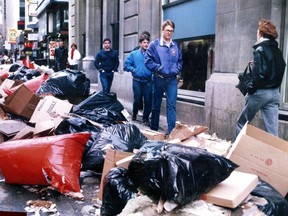 Pedestrians on Stanley St. walk by heaps of garbage on March 2, 1986 during a strike by Montreal blue collar workers. The photo was published March 3, 1986.