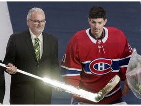 Canadiens goaltender Carey Price receives a gold stick from Michel Plante, son of Jacques Plante, prior to the game against the Chicago Blackhawks in Montreal on  Saturday, March 16, 2019. Price surpassed Jacques Plante's record of most wins by a Montreal Canadiens goalie earlier in the week.