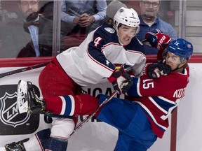 Canadiens centre Jesperi Kotkaniemi is taken out of the play by by Jackets defenceman during game in February. Kotkaniemi played the fewest minutes of his career Saturday night when he was benched by coach Claude Julien.