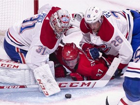 Carolina Hurricanes' Andrei Svechnikov is pushed to the ice by Montreal Canadiens goaltender Carey Price and defenceman Jeff Petry during second period NHL hockey action in Montreal on Thursday, December 13, 2018. Sunday's NHL games between the Montreal Canadiens and Carolina Hurricanes will be called in Plains Cree on Aboriginal Peoples Television Network for the first time.
