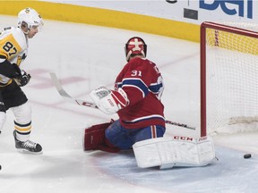 Pittsburgh Penguins' Sidney Crosby (87) scores on Montreal Canadiens goaltender Carey Price during first period NHL hockey action in Montreal, Saturday, March 2, 2019.