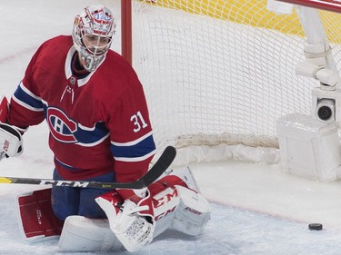 Montreal Canadiens goaltender Carey Price looks back on his net after being scored on by Buffalo Sabres' Sam Reinhart, not shown, during first period NHL hockey action in Montreal, Saturday, March 23, 2019.