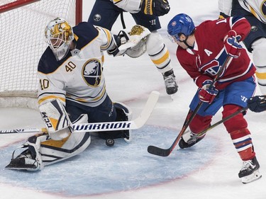 Montreal Canadiens' Brendan Gallagher (11) moves in on Buffalo Sabres goaltender Carter Hutton during first period NHL hockey action in Montreal, Saturday, March 23, 2019.