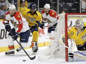 Florida Panthers left wing Jussi Jokinen (36), of Finland, brings the puck out from behind the net ahead of Nashville Predators defenceman Jonathan-Ismael Diaby (75) in the first period of a preseason NHL hockey game Sunday, Sept. 20, 2015, in Nashville, Tenn. The commissioner of a Quebec-based semi-professional hockey league has apologized after a player for the Jonquiere Marquis and family members in attendance were subjected to racist taunts from the stands in St-Jerome Saturday night. Diaby, a third-round draft choice for the NHL's Nashville Predators in 2013 who is black, left the game midway through the second period as a result of the abuse.THE CANADIAN PRESS/AP/Mark Humphrey ORG XMIT: CPT135